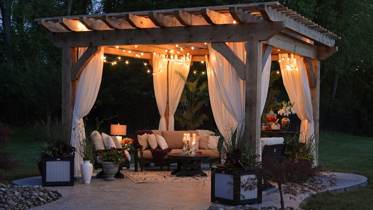 Backyard gazebo strung with string lights in the evening