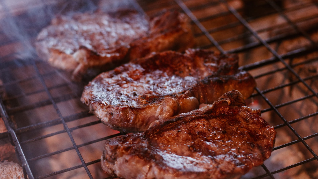Grilling meat on a charcoal barbecue outdoors