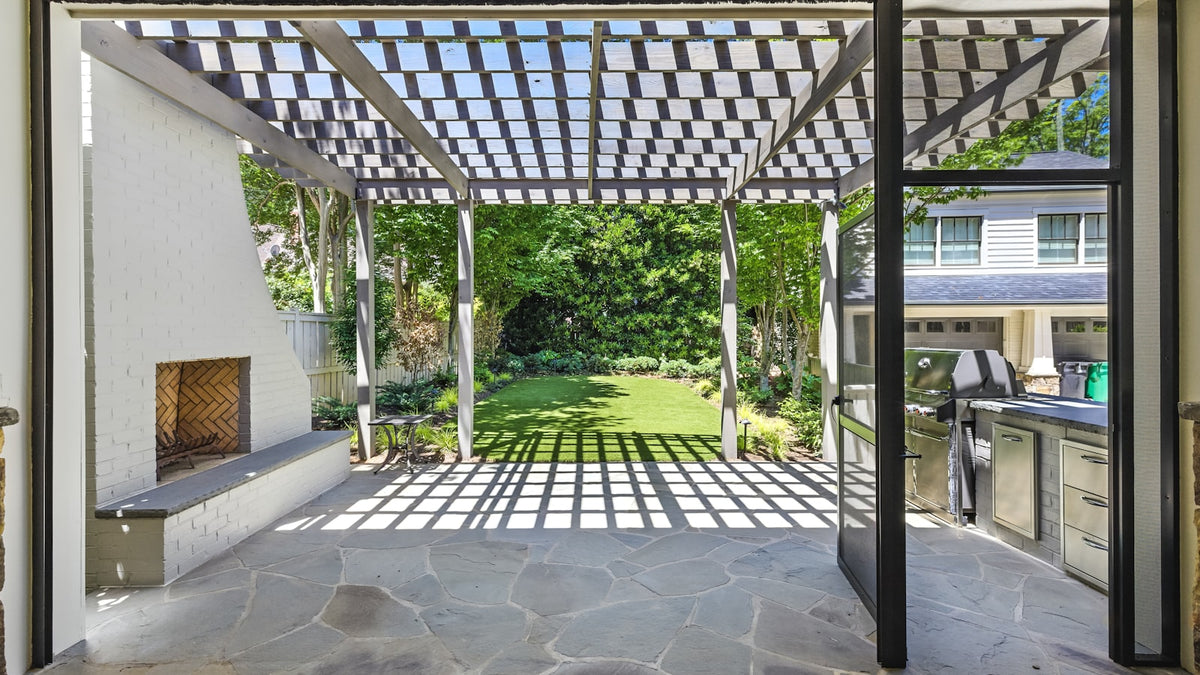 Modern patio with a pergola and outdoor kitchen