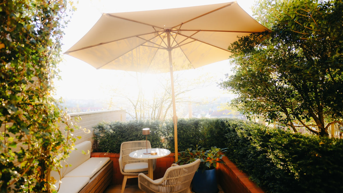 Outdoor patio seating area with umbrella and plants